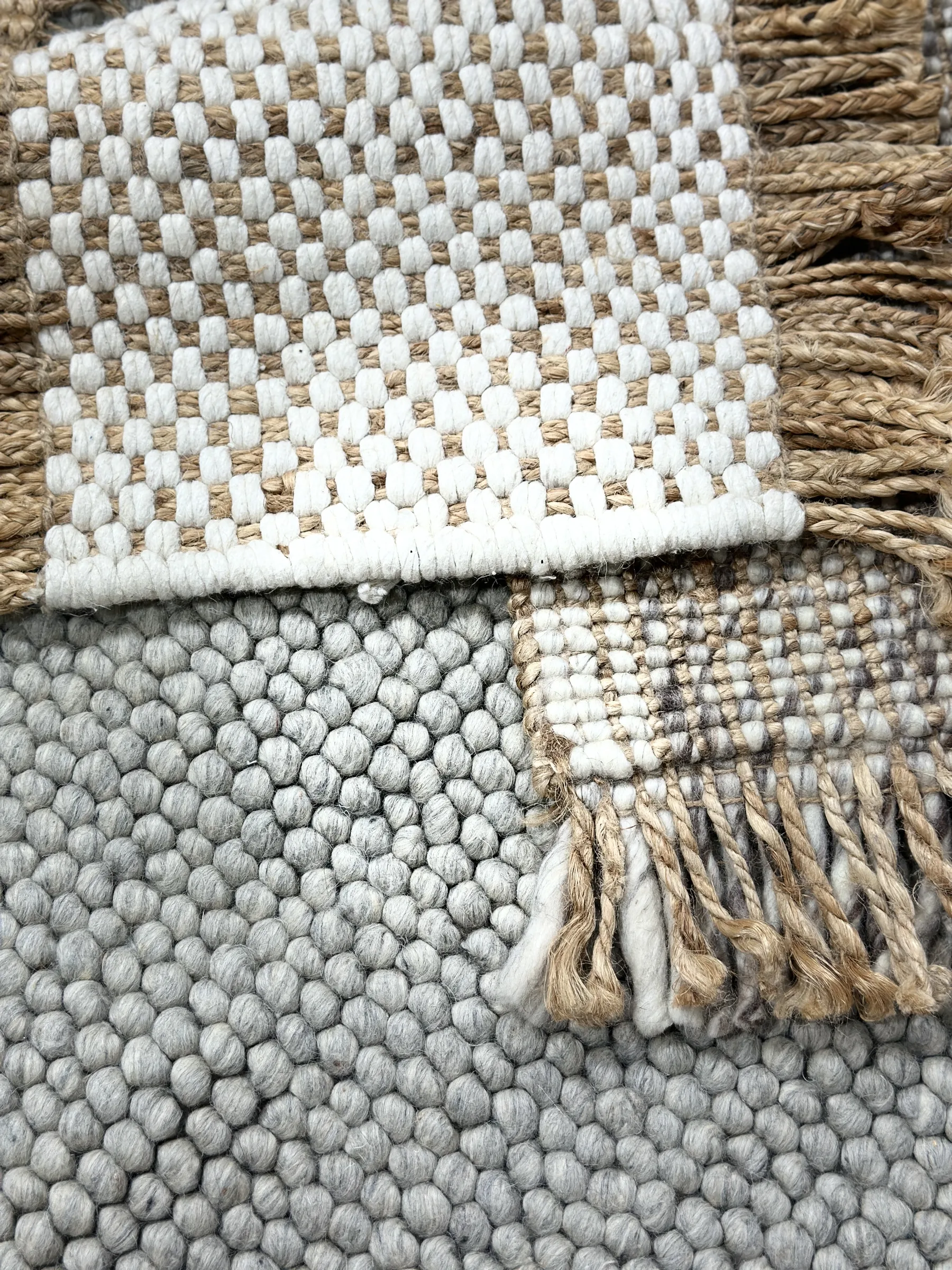 Third sample-library flatlay: brown and cream boucle textures next to plain-weave options