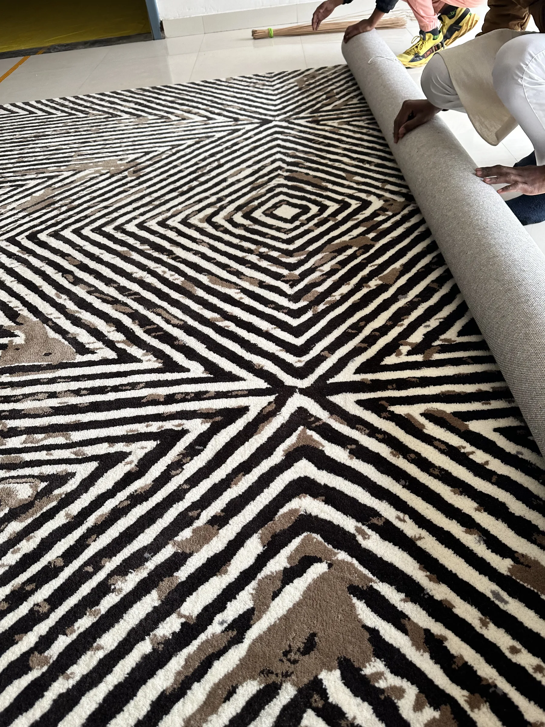 A closer view of workers on the PiHue Bhadohi finishing floor mid-programme