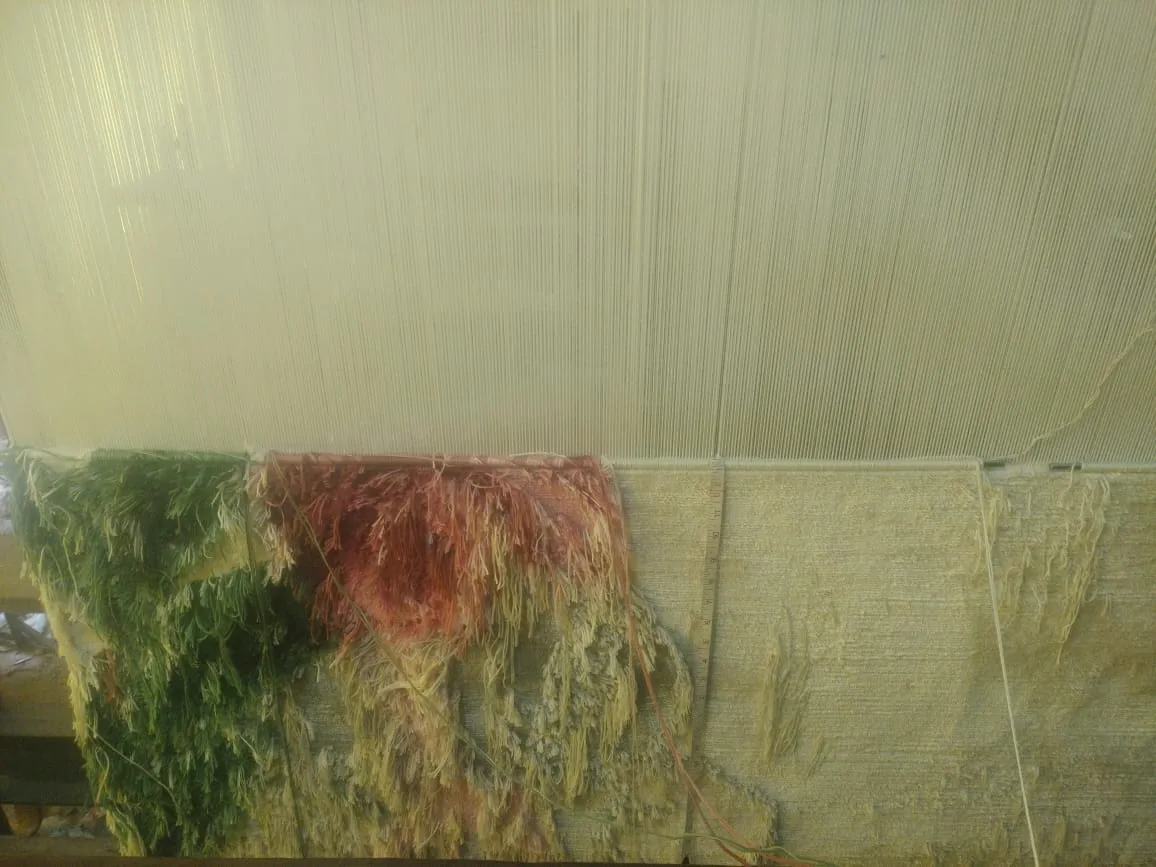 Hand-knotted silk rug in progress on the loom