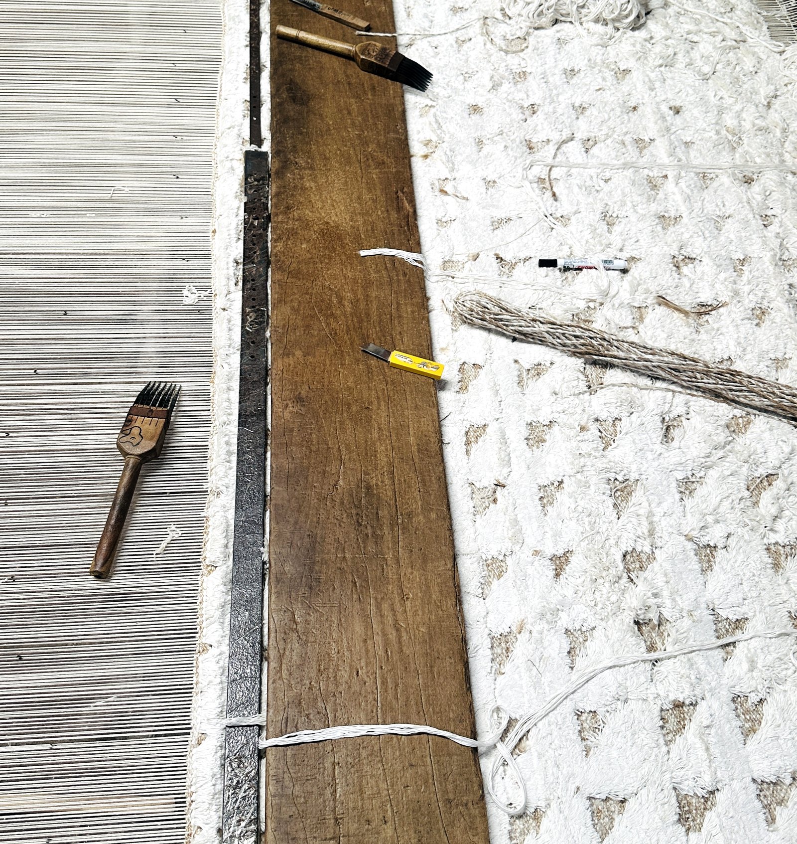 Stage 04 — a rug in progress on the loom, warp tensioned, weft beaten down