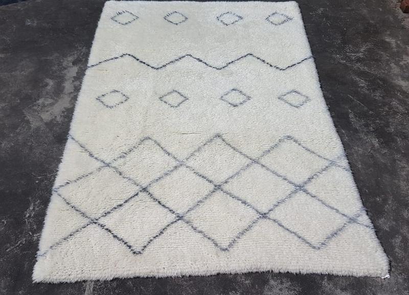 Ivory shag rug with charcoal diamond lattice and chevron bands, shown flat