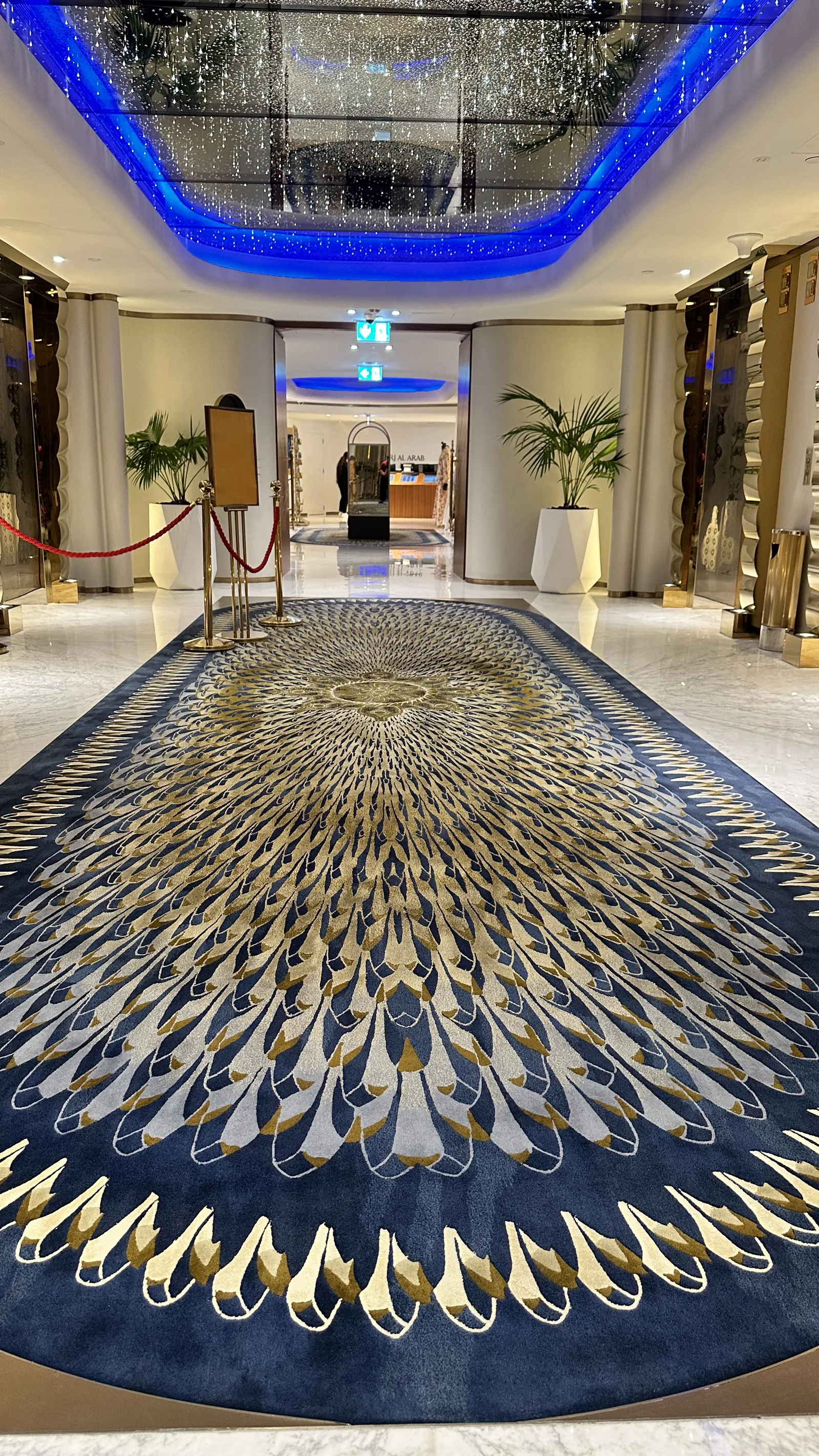 An oval hand-knotted rug installed in a hotel guest room