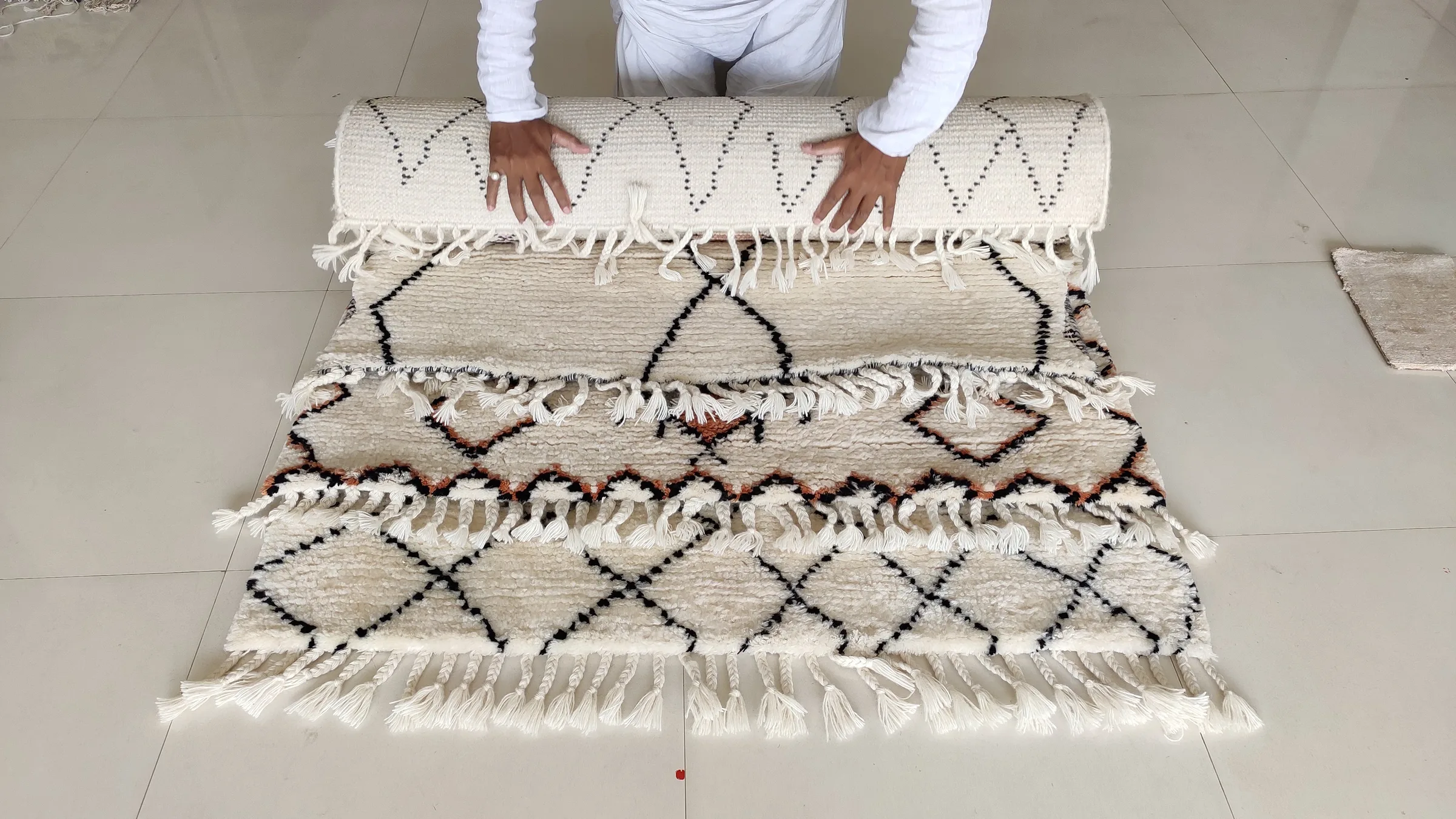 Shipment labels applied to a wrapped rug bundle at the despatch bay