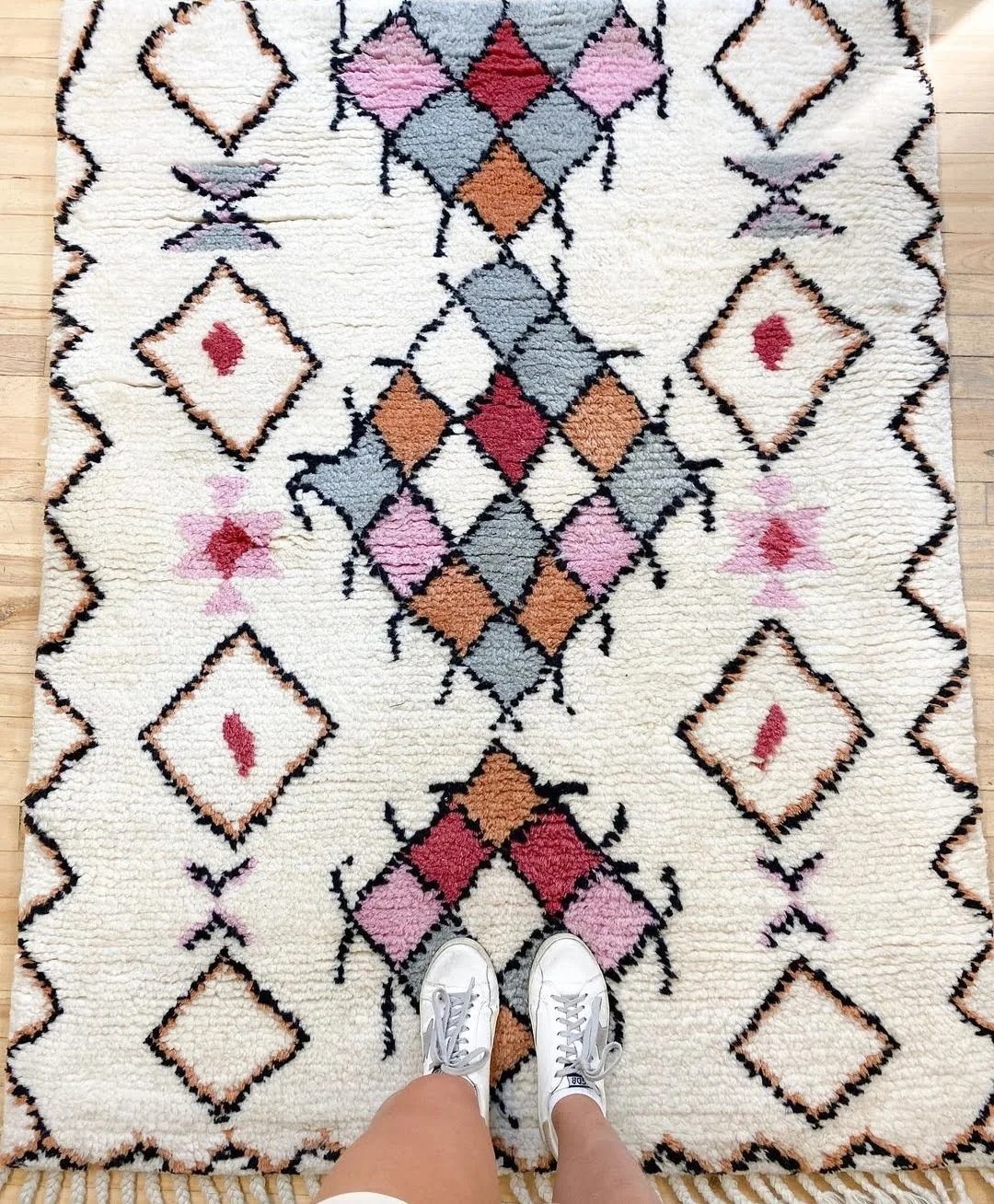 Hand-knotted wool rug with a geometric medallion column, finished and styled before dispatch