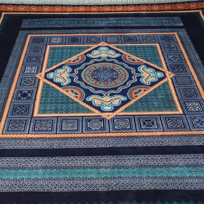Silk hand-knotted rug with a navy, teal and orange medallion design, woven in Bhadohi