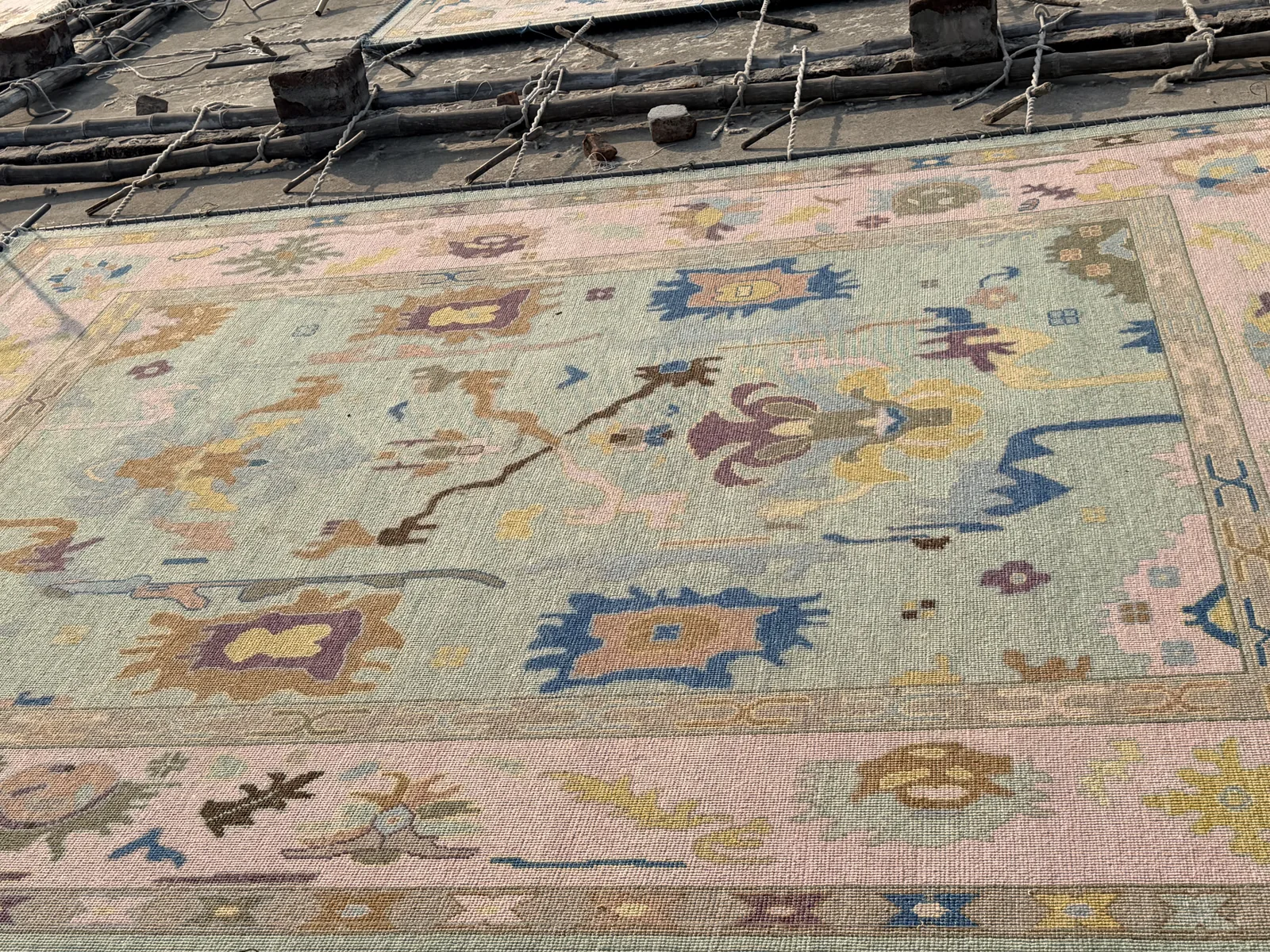 A large hand-knotted rug sun-drying on the roof after washing