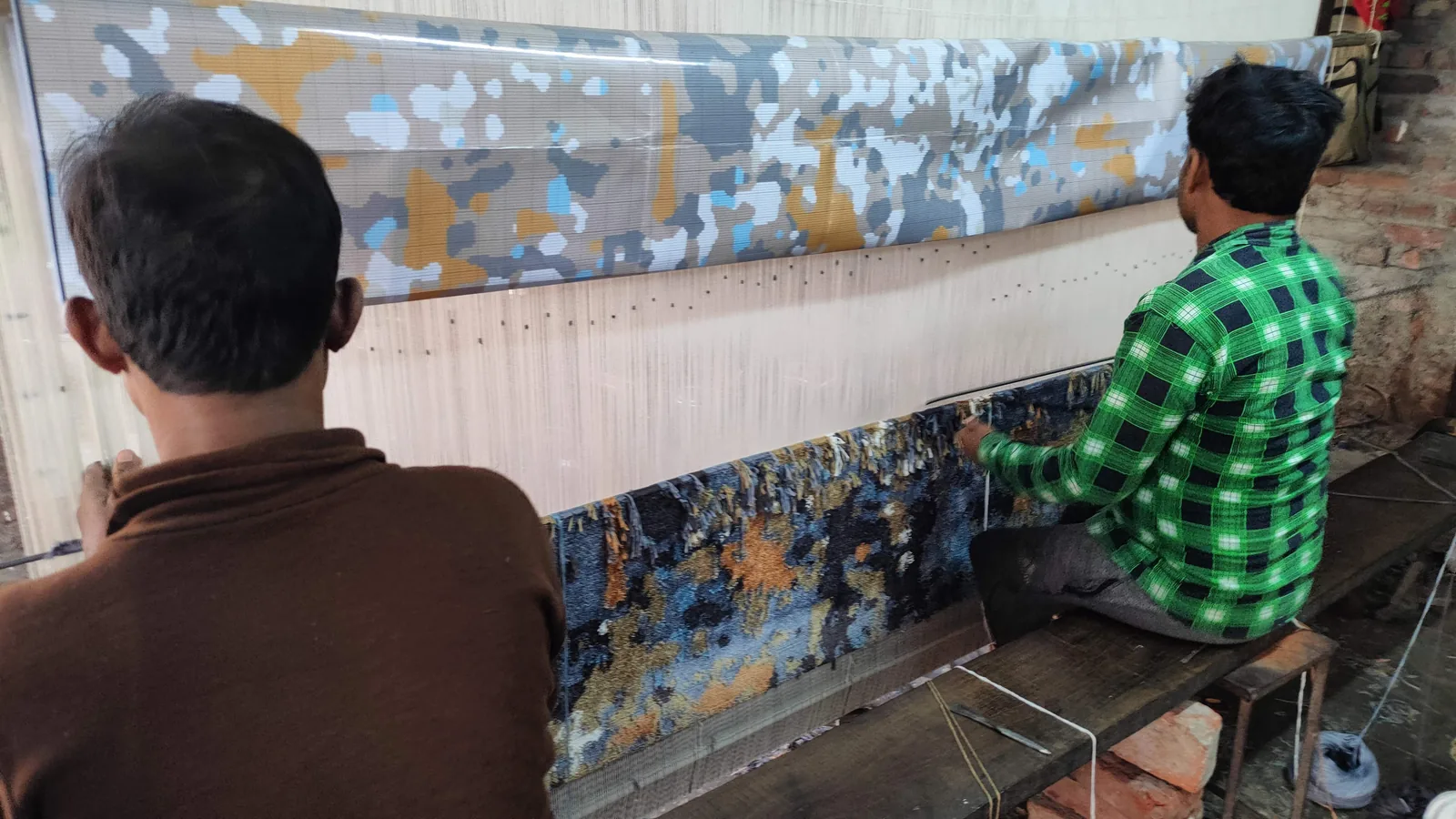 Silk being knotted into a rug as accent highlights