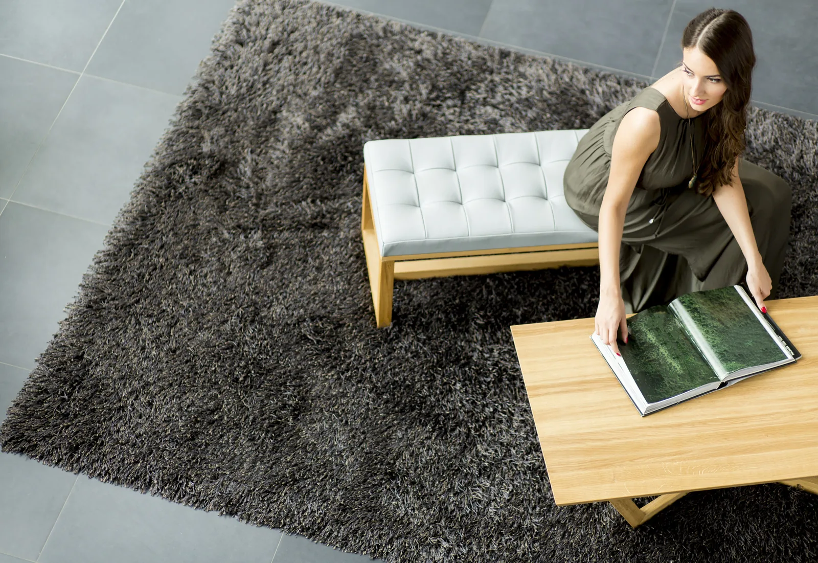 A dark silk-blend shag rug catching the light in a modern interior — the sheen silk is prized for
