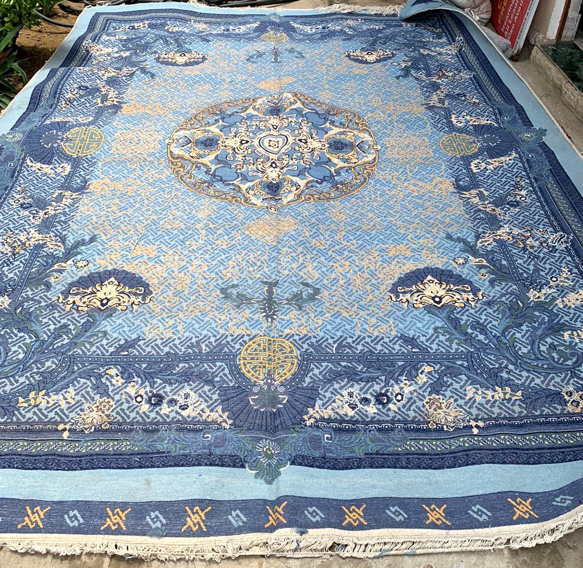 The finished blue silk rug, laid flat for inspection before dispatch